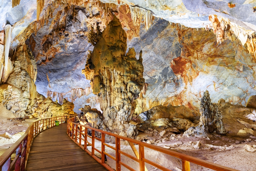 Wooden walkway among beautiful stalagmites inside Paradise Cave